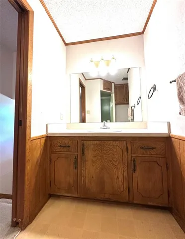 a bathroom with a sink vanity and a mirror