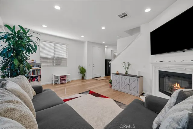 a living room with furniture fireplace and flat screen tv