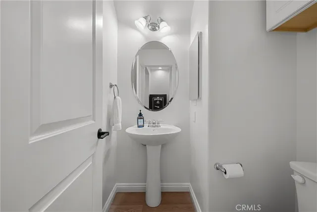 a bathroom with a sink a mirror a toilet and vanity