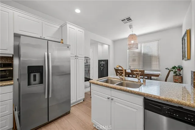 a kitchen with refrigerator a sink and cabinets