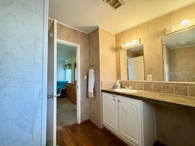 a bathroom with a double vanity sink and a mirror
