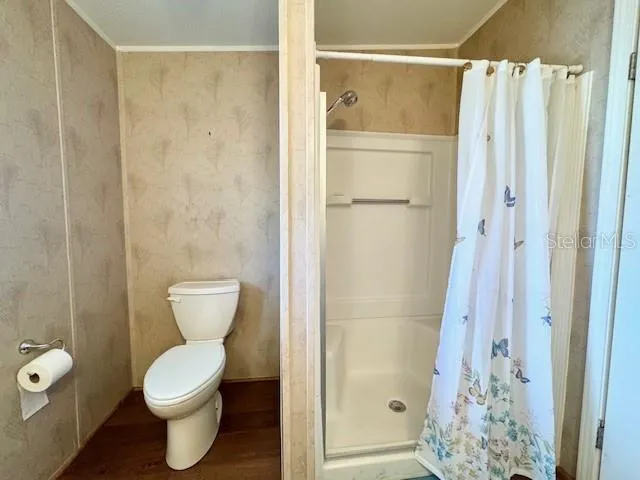 a bathroom with a toilet and shower