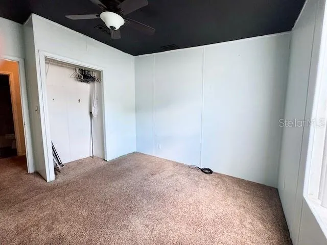 a view of a room with wooden floor and a chair