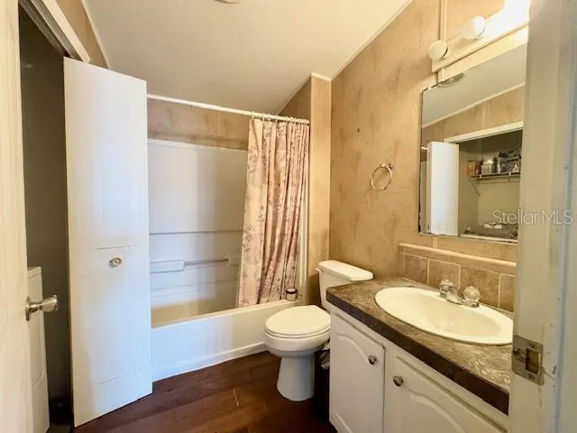 a bathroom with a sink toilet tub and shower