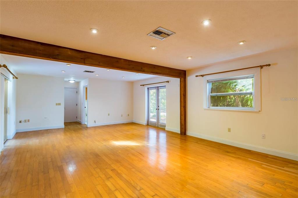 1647 Hobbit Road Dunedin, FL 34698 - Photo 22 of 36 a view of an empty room with wooden floor and a window