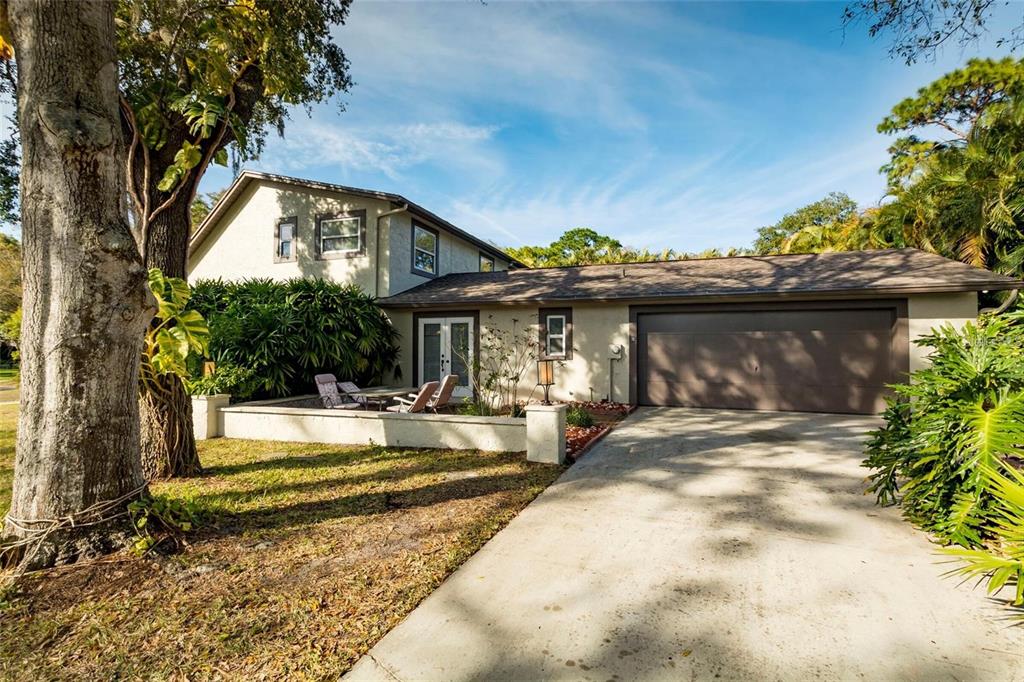 1647 Hobbit Road Dunedin, FL 34698 - Photo 6 of 36 a view of a house with a fountain and flower plants