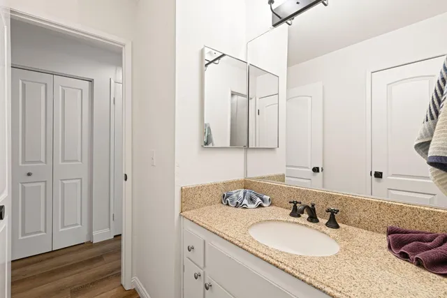 a bathroom with 2 sink tub and a mirror