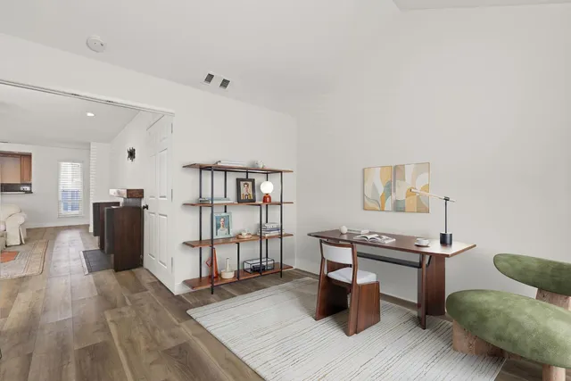 a living room with furniture a flat screen tv and a table