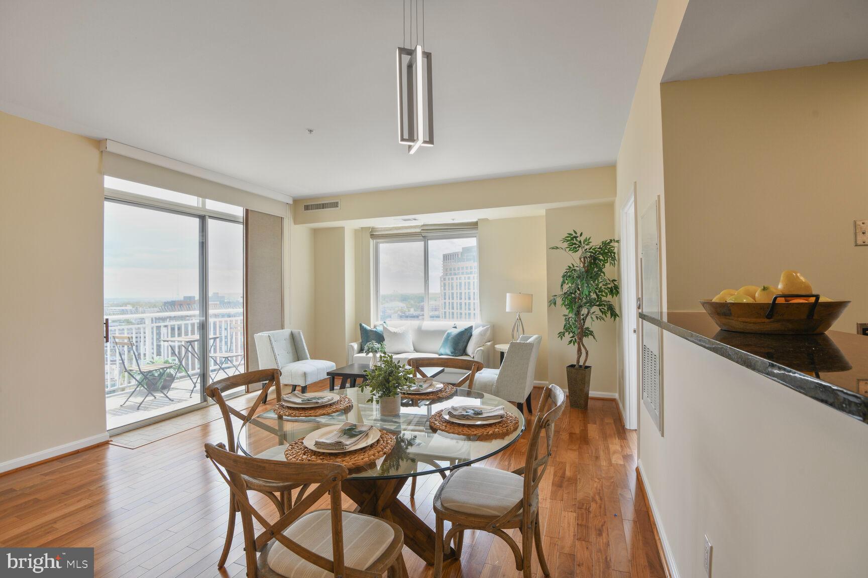 930 Wayne Avenue, Unit 1403 Silver Spring, MD 20910 - Photo 11 of 37 a view of a dining room with furniture window and wooden floor