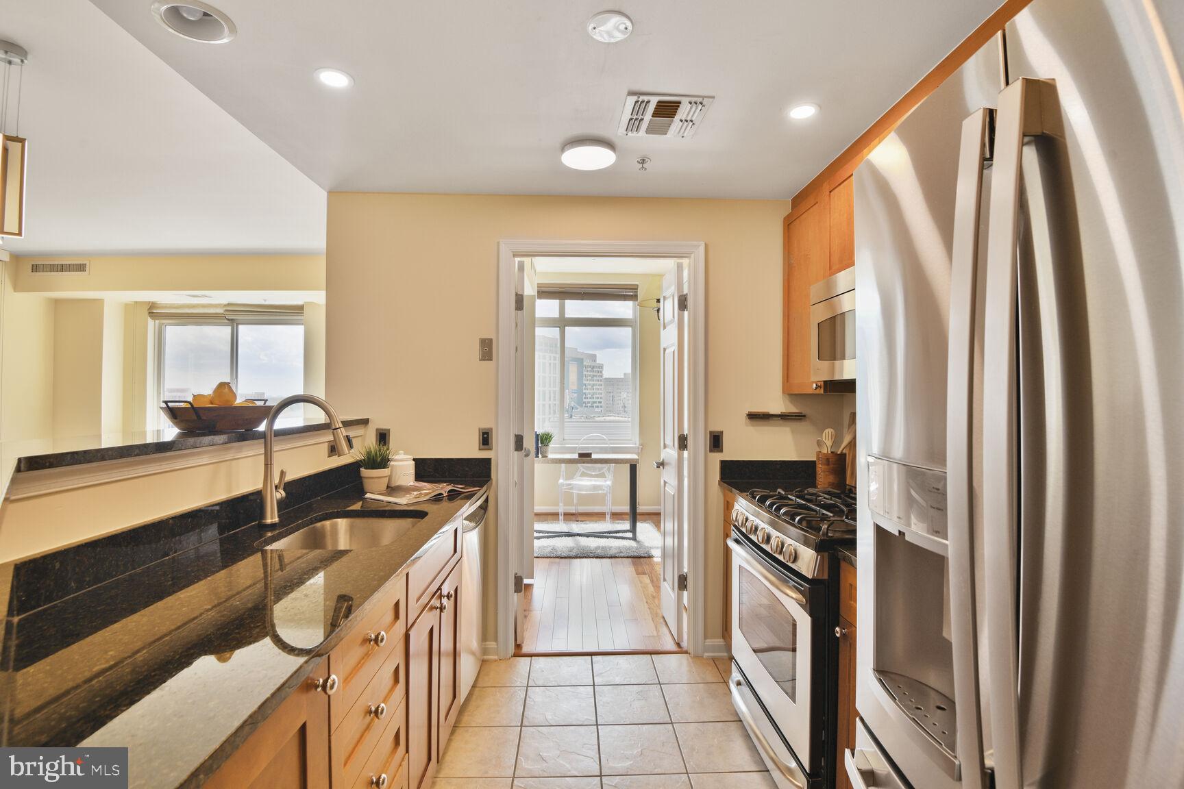930 Wayne Avenue, Unit 1403 Silver Spring, MD 20910 - Photo 12 of 37 a kitchen with a refrigerator and a stove