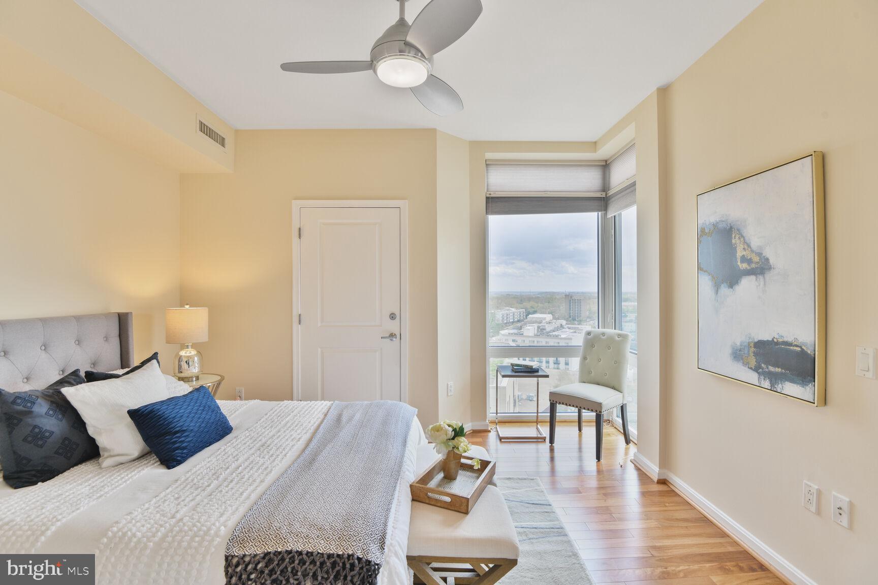 930 Wayne Avenue, Unit 1403 Silver Spring, MD 20910 - Photo 17 of 37 a bedroom with a bed and wooden floor