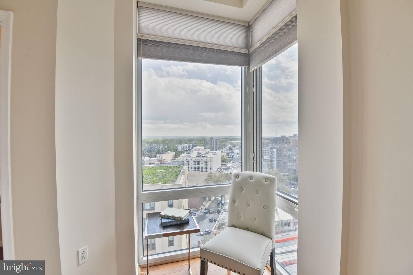930 Wayne Avenue, Unit 1403 Silver Spring, MD 20910 - Photo 18 of 37 a view of a room with a large window and wooden floor