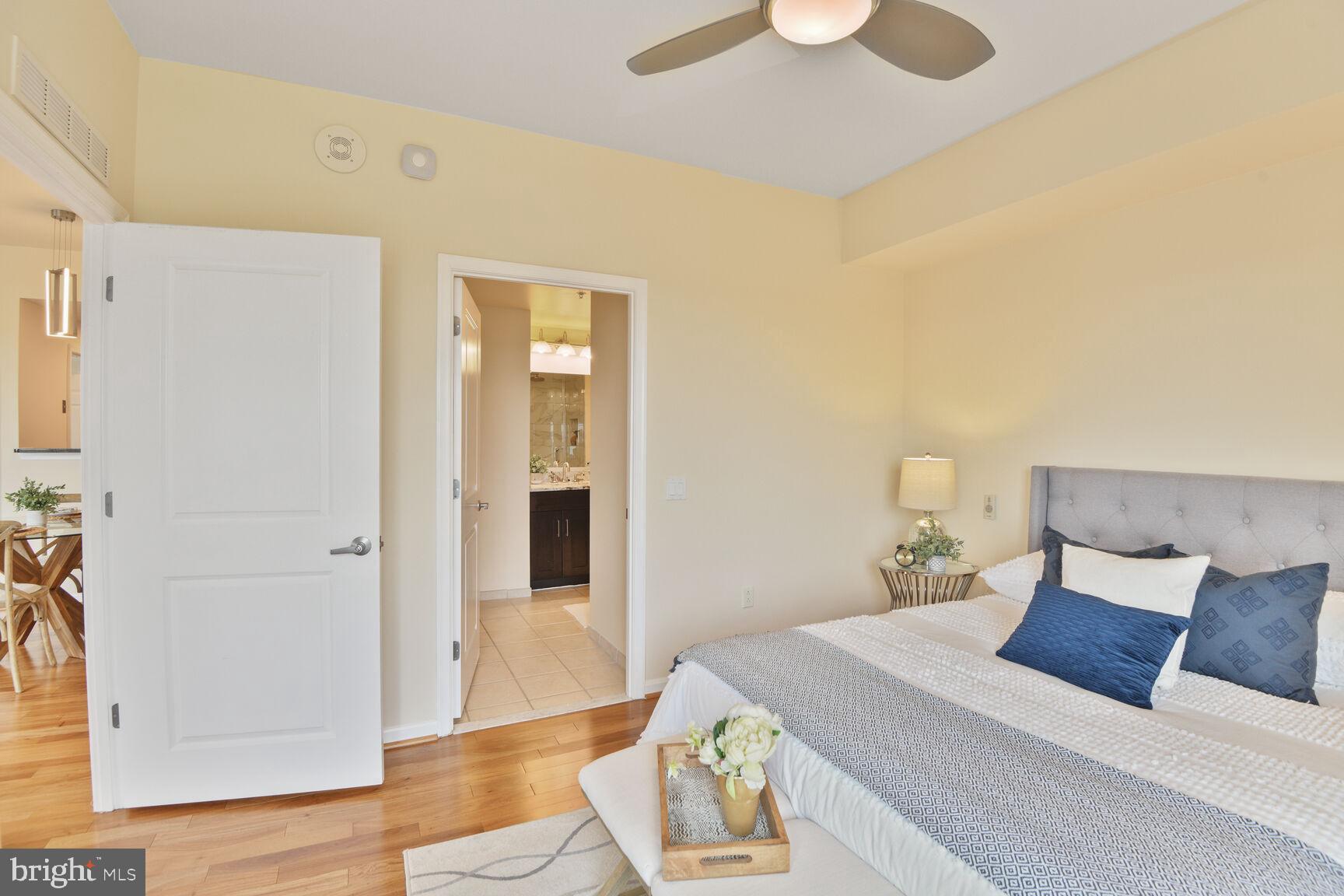 930 Wayne Avenue, Unit 1403 Silver Spring, MD 20910 - Photo 19 of 37 a bed room with a bed and a window