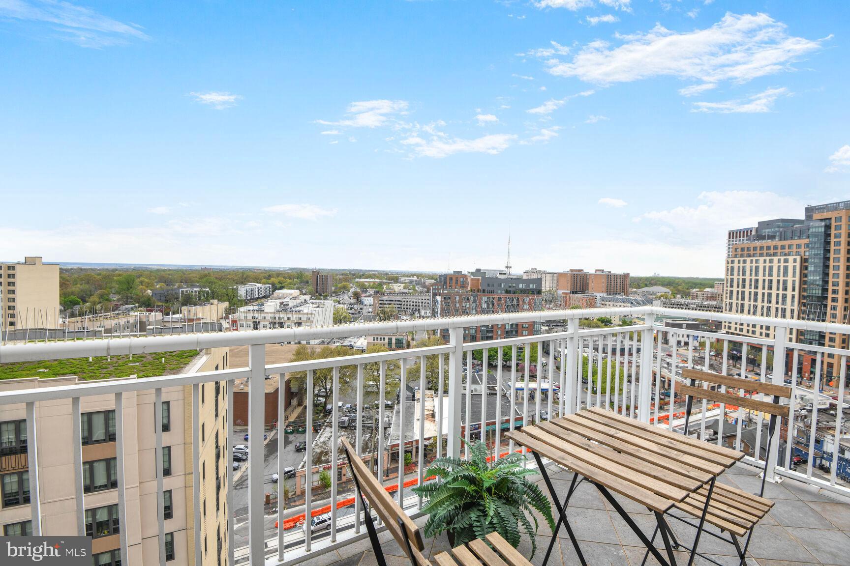 930 Wayne Avenue, Unit 1403 Silver Spring, MD 20910 - Photo 26 of 37 a view of a balcony with wooden chairs