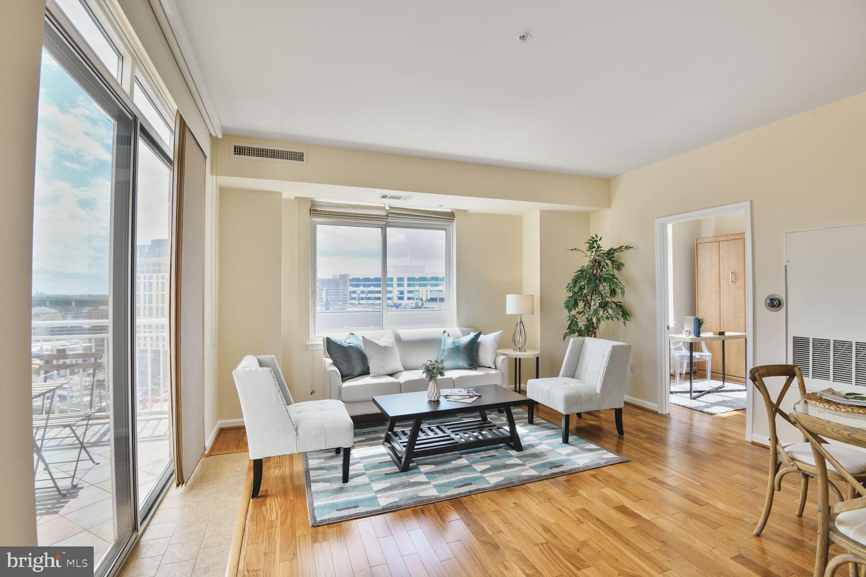 930 Wayne Avenue, Unit 1403 Silver Spring, MD 20910 - Photo 8 of 37 a living room with furniture and a wooden floor