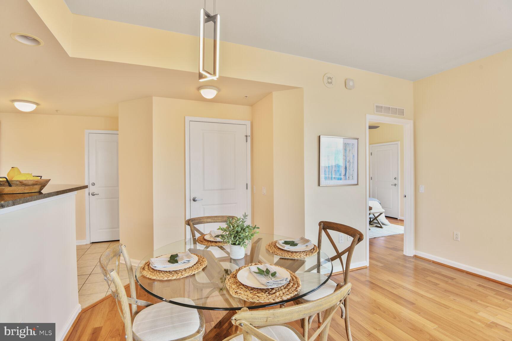 930 Wayne Avenue, Unit 1403 Silver Spring, MD 20910 - Photo 10 of 37 a view of a dining room with furniture and wooden floor