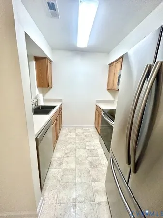 a kitchen with granite countertop a sink stove and refrigerator