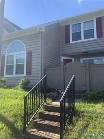 a front view of house with deck and garden