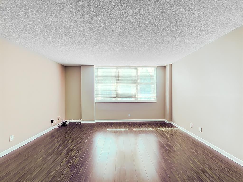 1147 Hillsboro Mile, Unit 506 Hillsboro Beach, FL 33062 - Photo 15 of 45 an empty room with wooden floor and windows