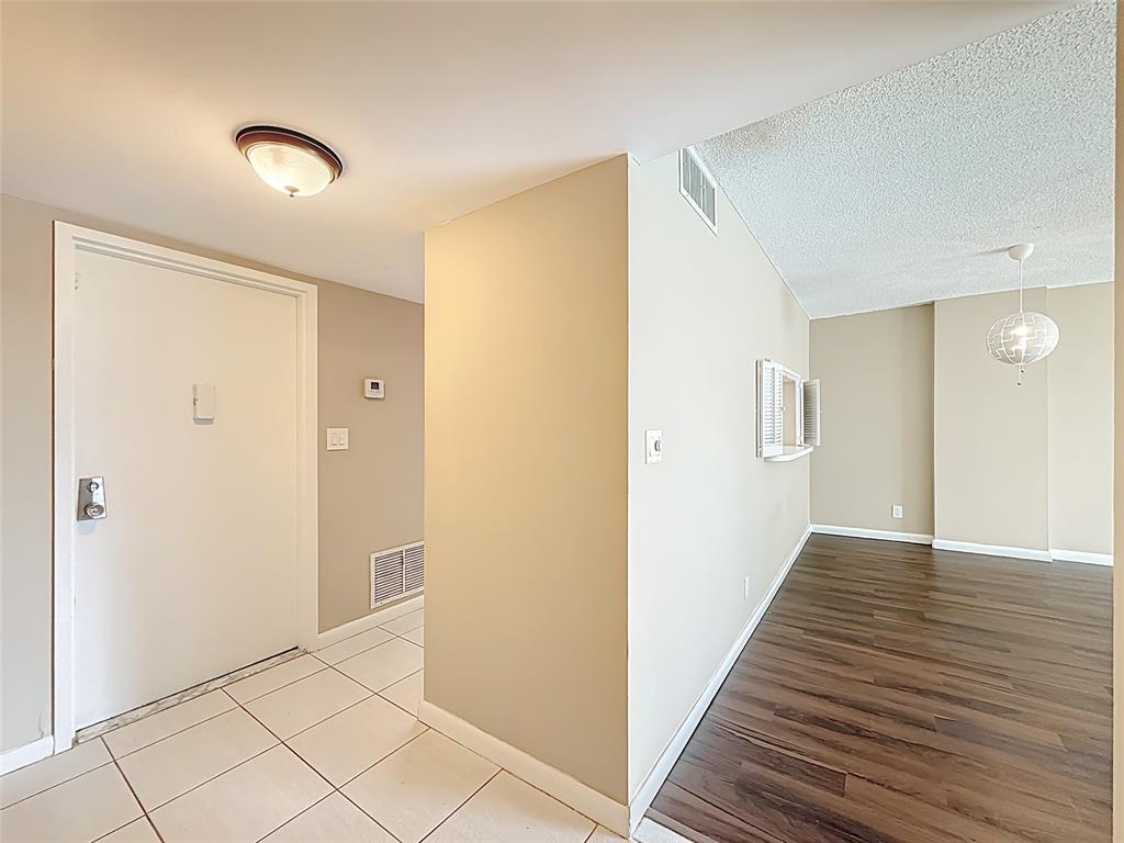 1147 Hillsboro Mile, Unit 506 Hillsboro Beach, FL 33062 - Photo 16 of 45 a view of a hallway with wooden floor