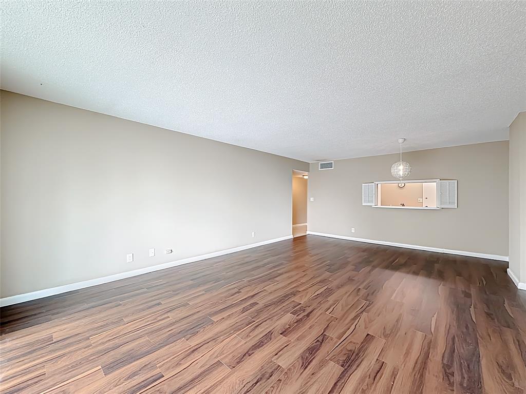 1147 Hillsboro Mile, Unit 506 Hillsboro Beach, FL 33062 - Photo 19 of 45 a view of an empty room with wooden floor and a window