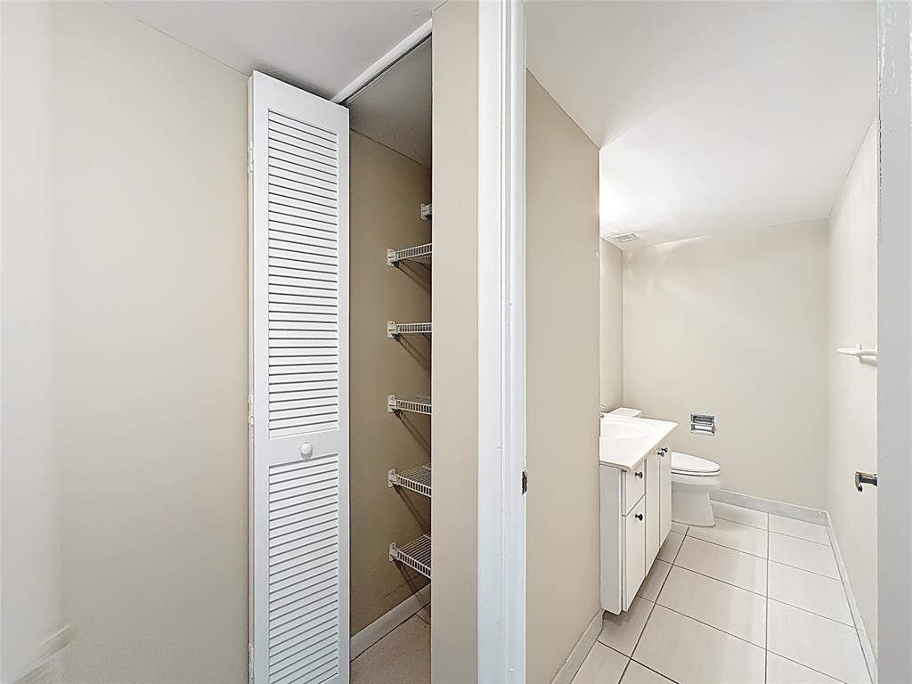 1147 Hillsboro Mile, Unit 506 Hillsboro Beach, FL 33062 - Photo 21 of 45 a view of a bathroom with a sink and a toilet