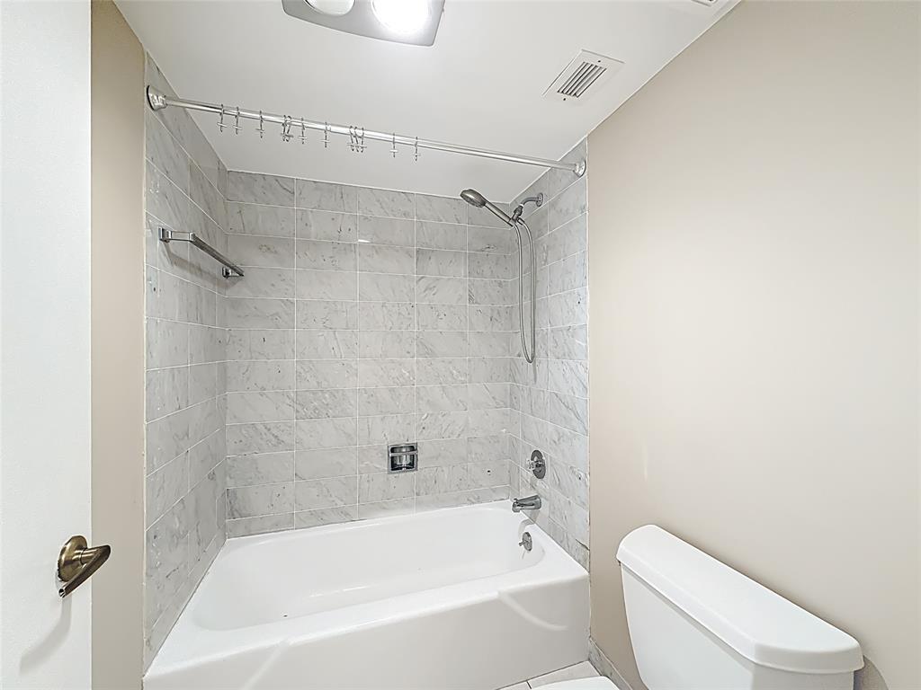 1147 Hillsboro Mile, Unit 506 Hillsboro Beach, FL 33062 - Photo 27 of 45 a bathroom with a toilet and a bathtub