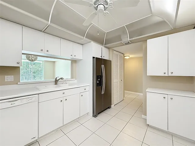 a kitchen with a sink cabinets and refrigerator