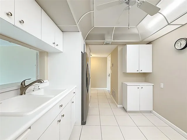 a spacious bathroom with a double vanity sink a mirror and a bathtub