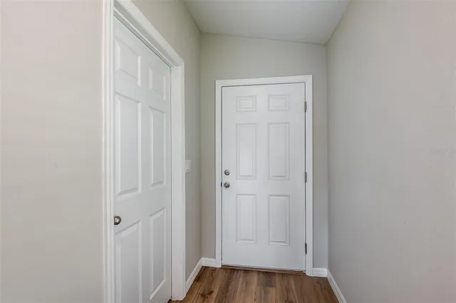 a view of a hallway with wooden floor