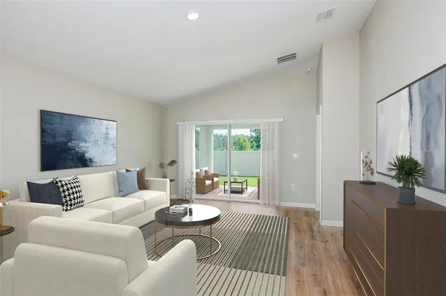 a living room with furniture and a large window