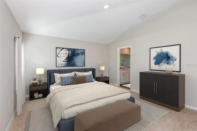 a bedroom with a bed and a painting on the wall