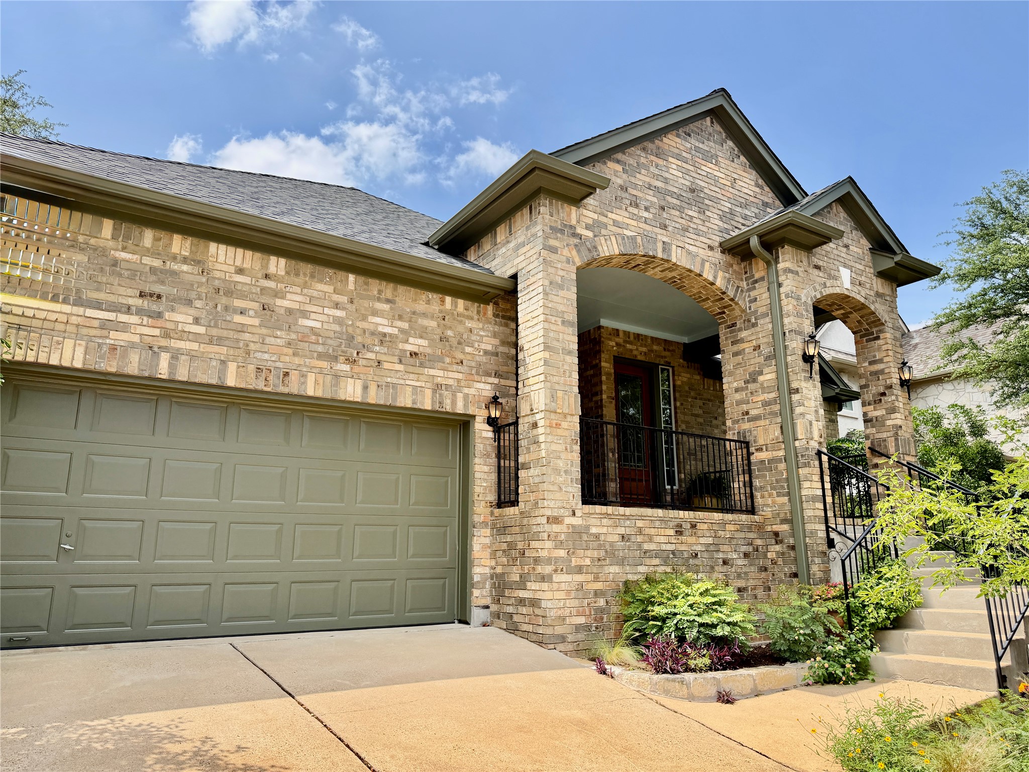 8024 Cobblestone Austin, TX 78735 - Photo 1 of 31 Brick exterior with arched entryways and large covered porch