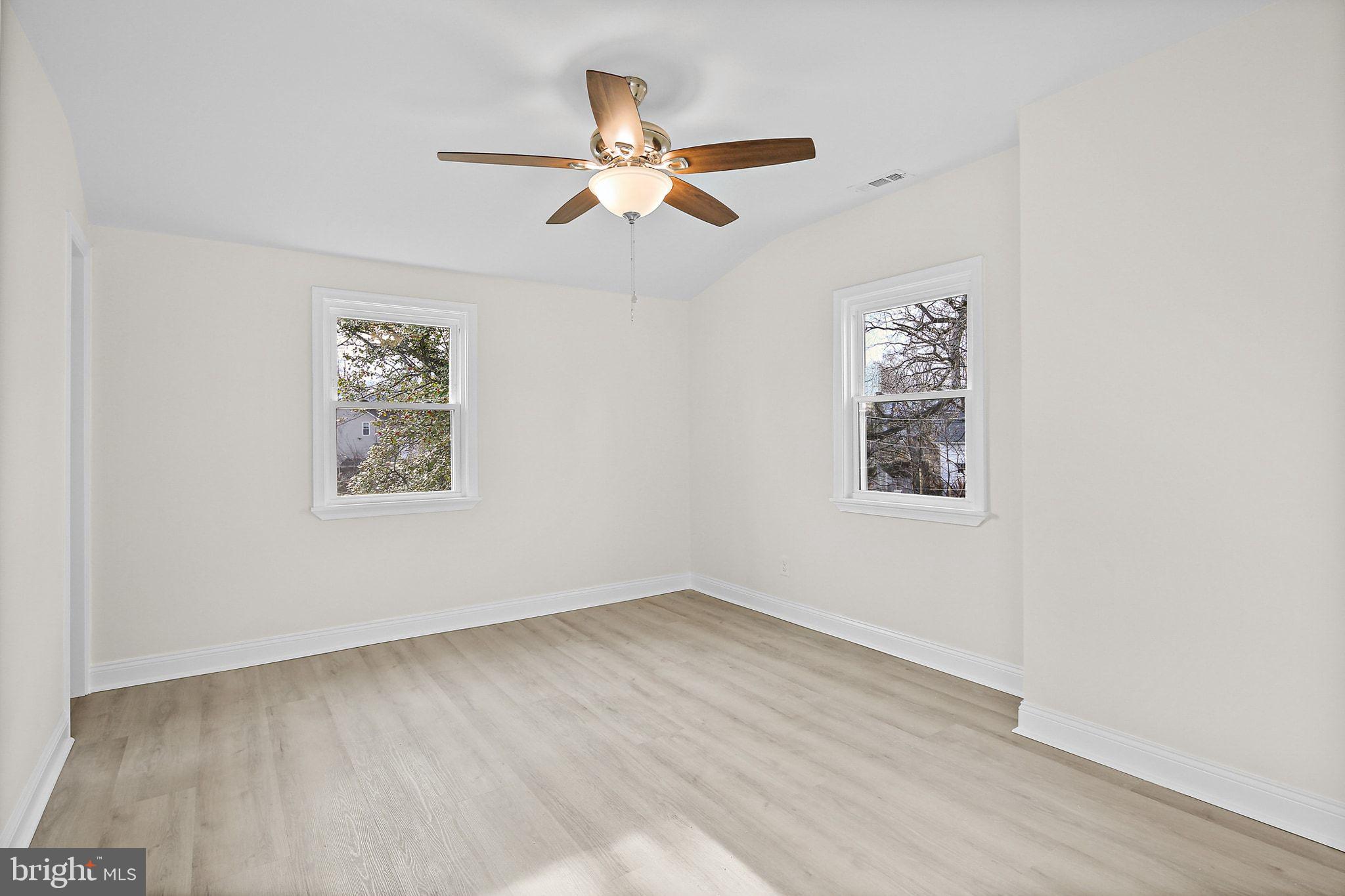 402 Westgate Road Baltimore, MD 21229 - Photo 19 of 34 an empty room with wooden floor and windows