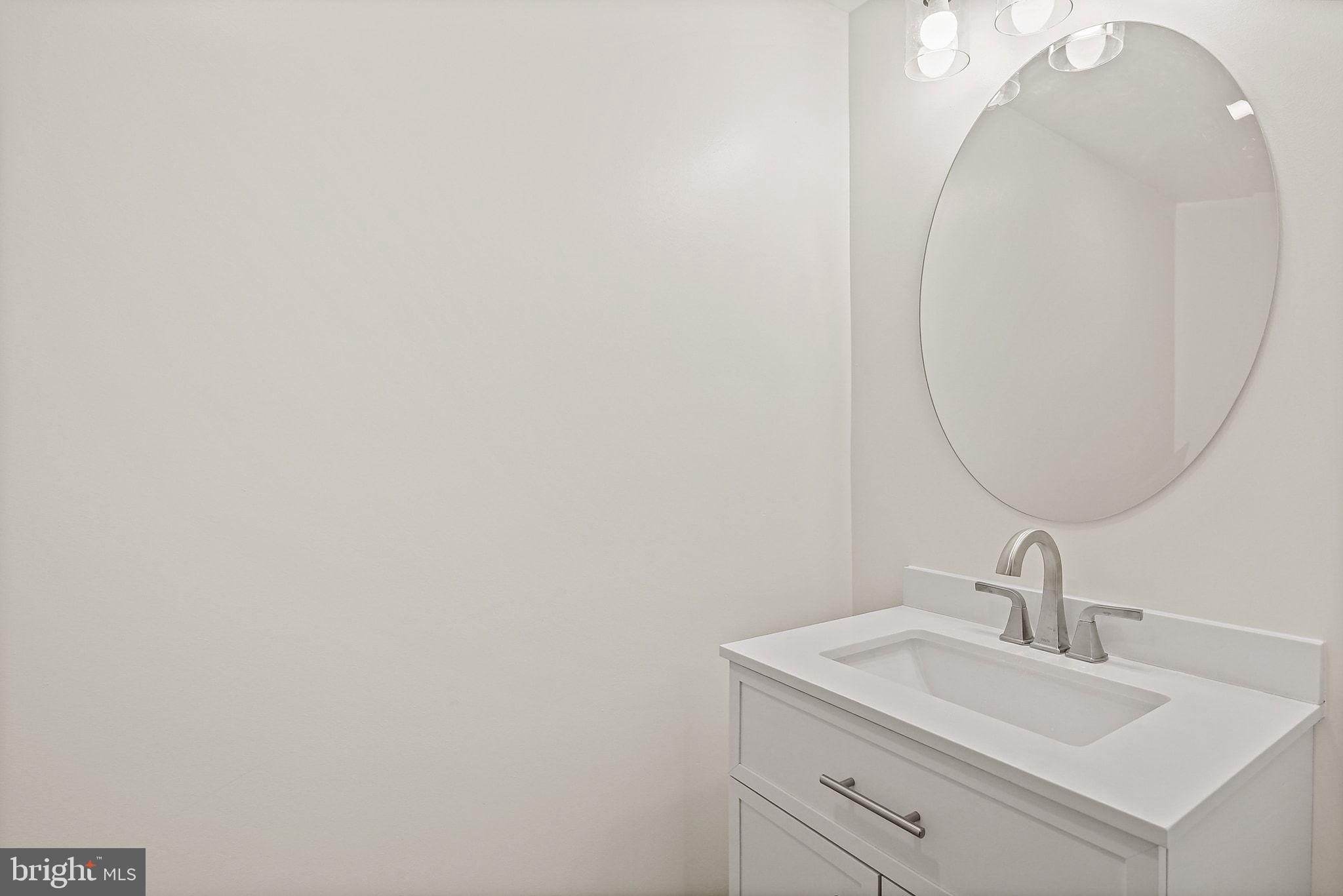 402 Westgate Road Baltimore, MD 21229 - Photo 27 of 34 a bathroom with a sink and a mirror