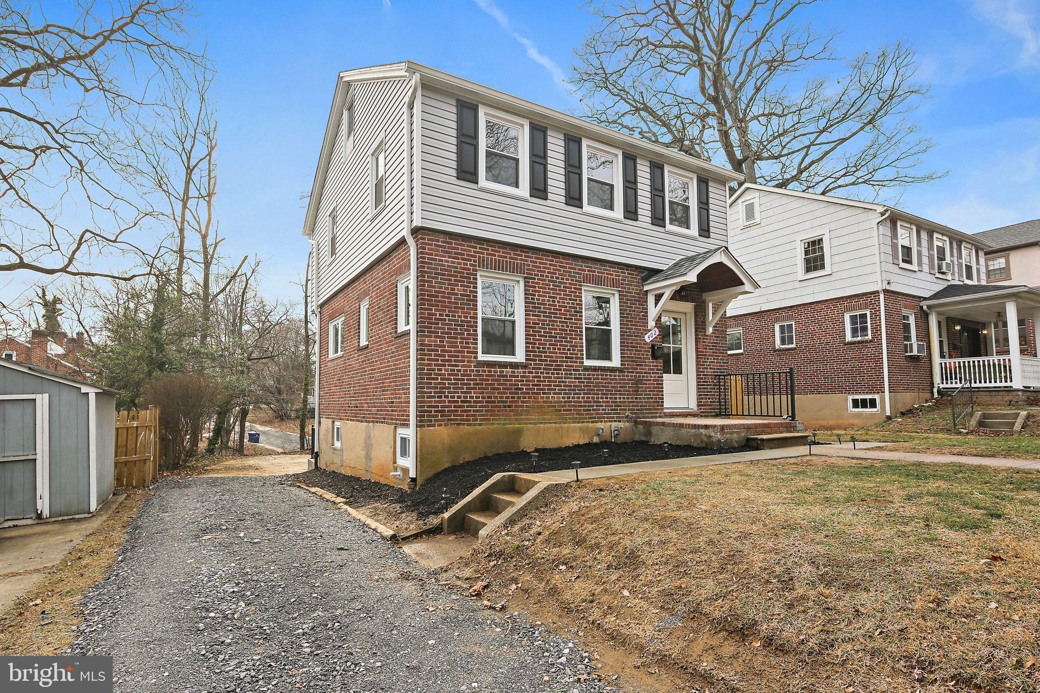 402 Westgate Road Baltimore, MD 21229 - Photo 3 of 34 a front view of a house with a yard