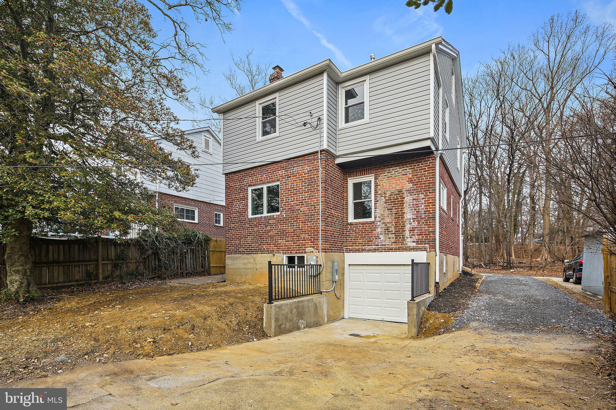 402 Westgate Road Baltimore, MD 21229 - Photo 33 of 34 a front view of a house with a yard and garage