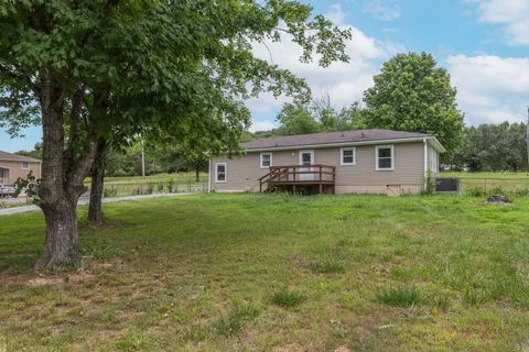 a view of house with backyard
