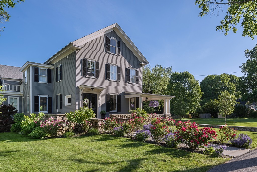 392 Main Street Hingham, MA 02043 - Photo 2 of 30 a front view of house and yard with beautiful flowers and green space