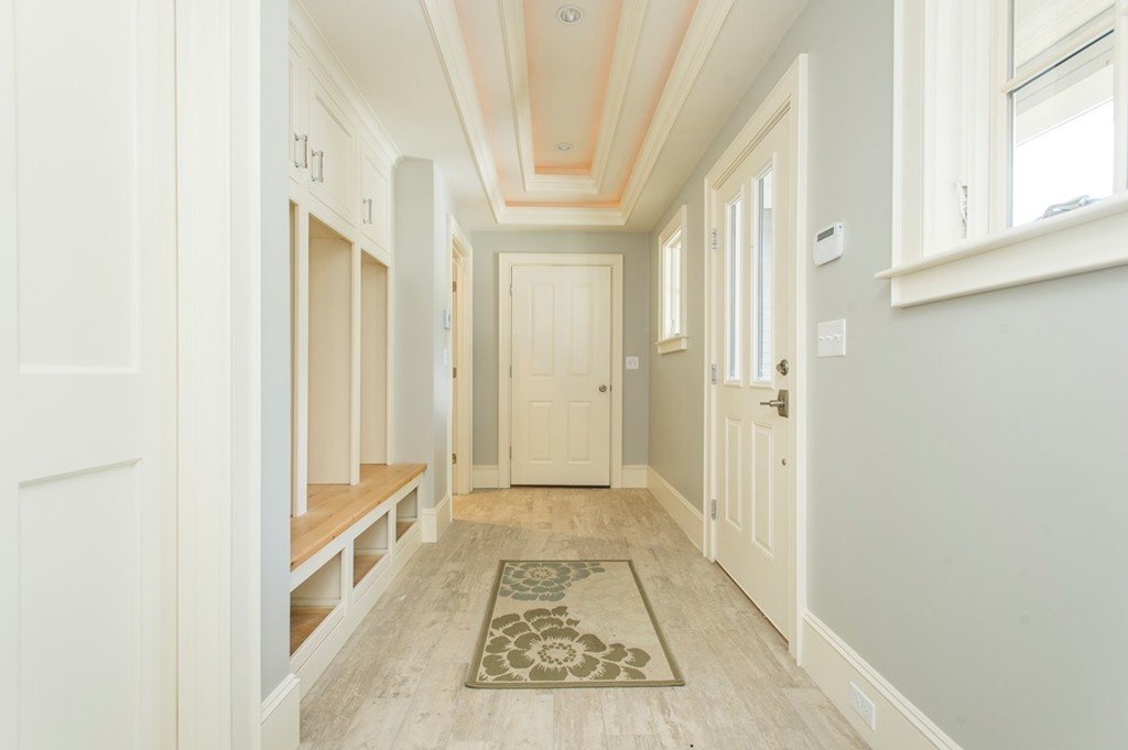 392 Main Street Hingham, MA 02043 - Photo 26 of 30 a view of a hallway with wooden floor and staircase