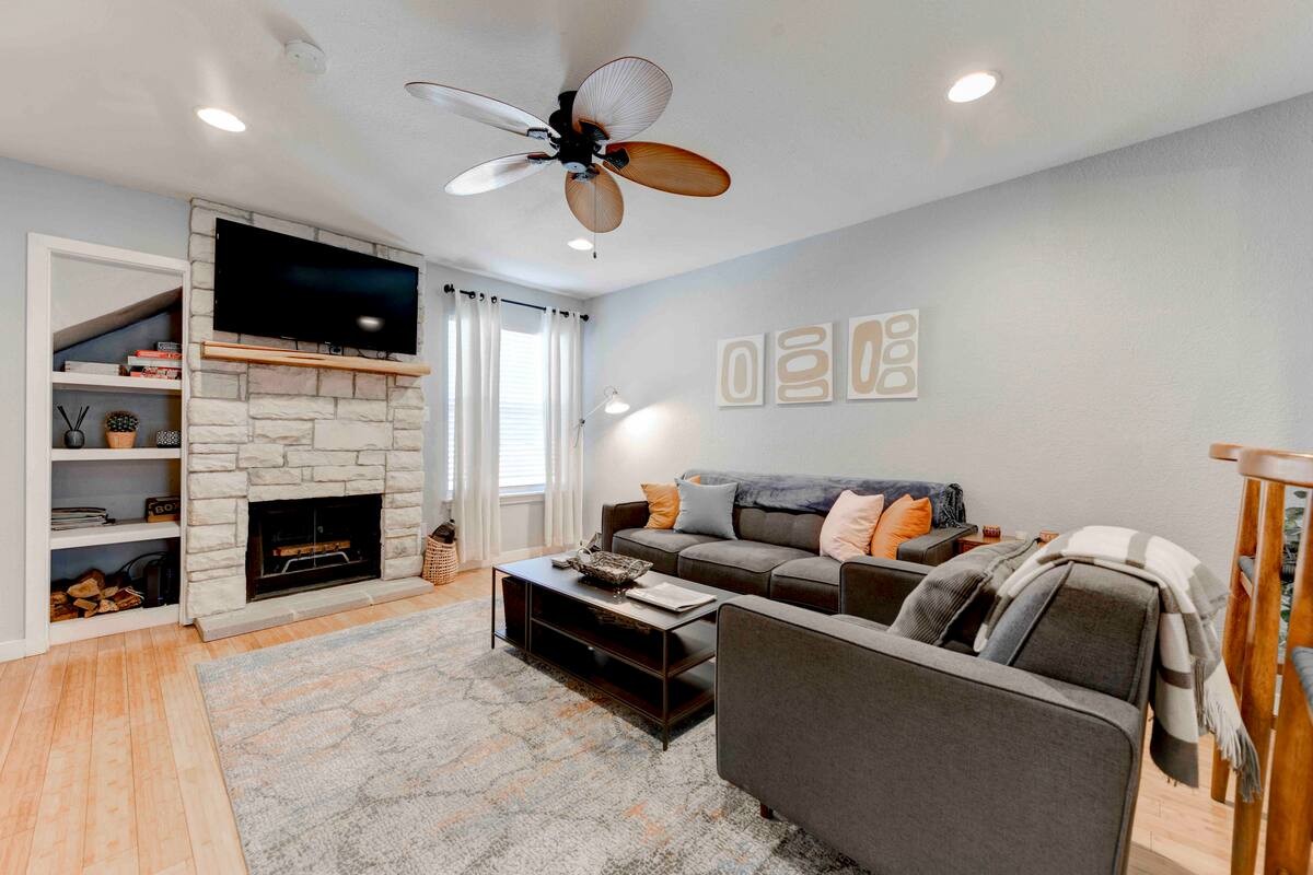 a living room with furniture a fireplace and a flat screen tv