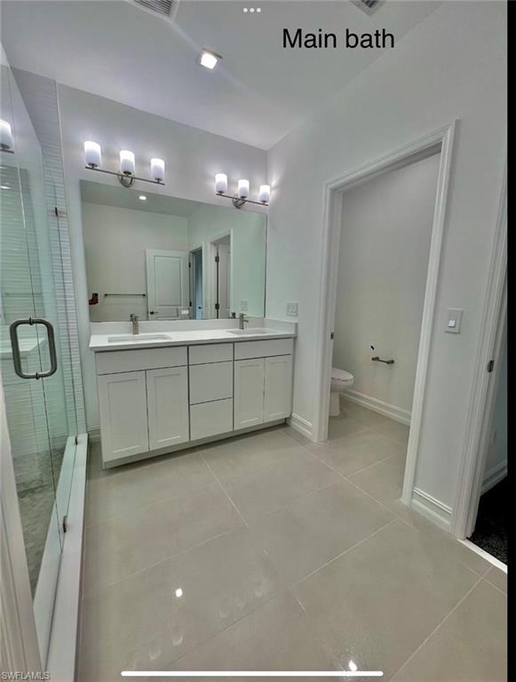7452 Rockefeller Drive Naples, FL 34119 - Photo 13 of 19 a large bathroom with a sink mirror and a bath tub