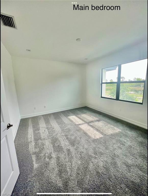 7452 Rockefeller Drive Naples, FL 34119 - Photo 16 of 19 an empty room with windows