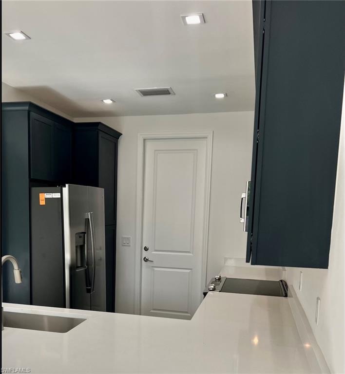 7452 Rockefeller Drive Naples, FL 34119 - Photo 4 of 19 a bathroom with a sink and a mirror