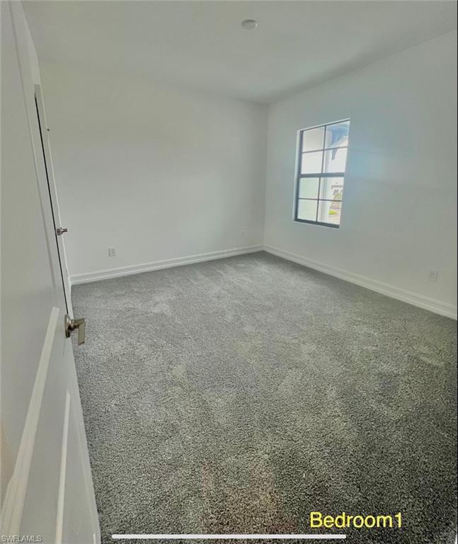 7452 Rockefeller Drive Naples, FL 34119 - Photo 8 of 19 an empty room with windows