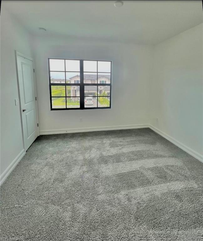 7452 Rockefeller Drive Naples, FL 34119 - Photo 9 of 19 an empty room with windows and tub
