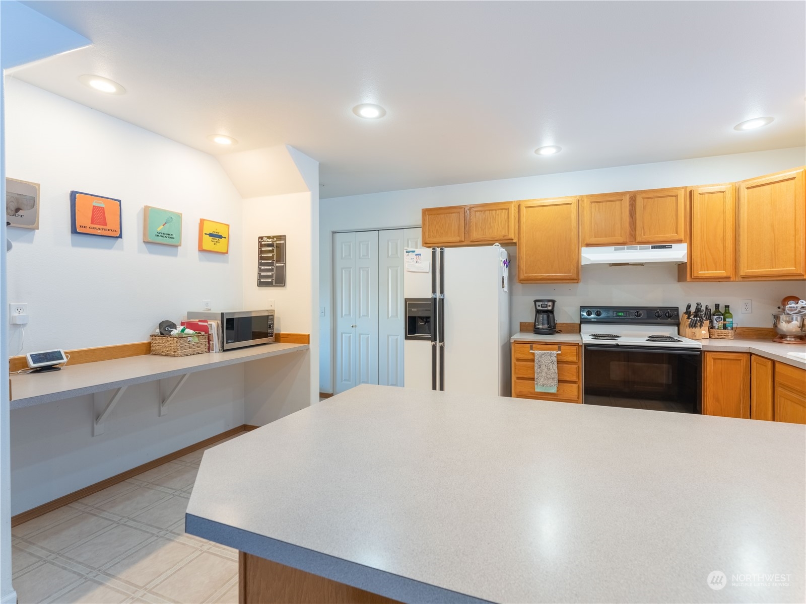 14918 Burkey Street Entiat, WA 98822 - Photo 12 of 39 a large kitchen with stainless steel appliances kitchen island granite countertop a refrigerator and a stove top oven