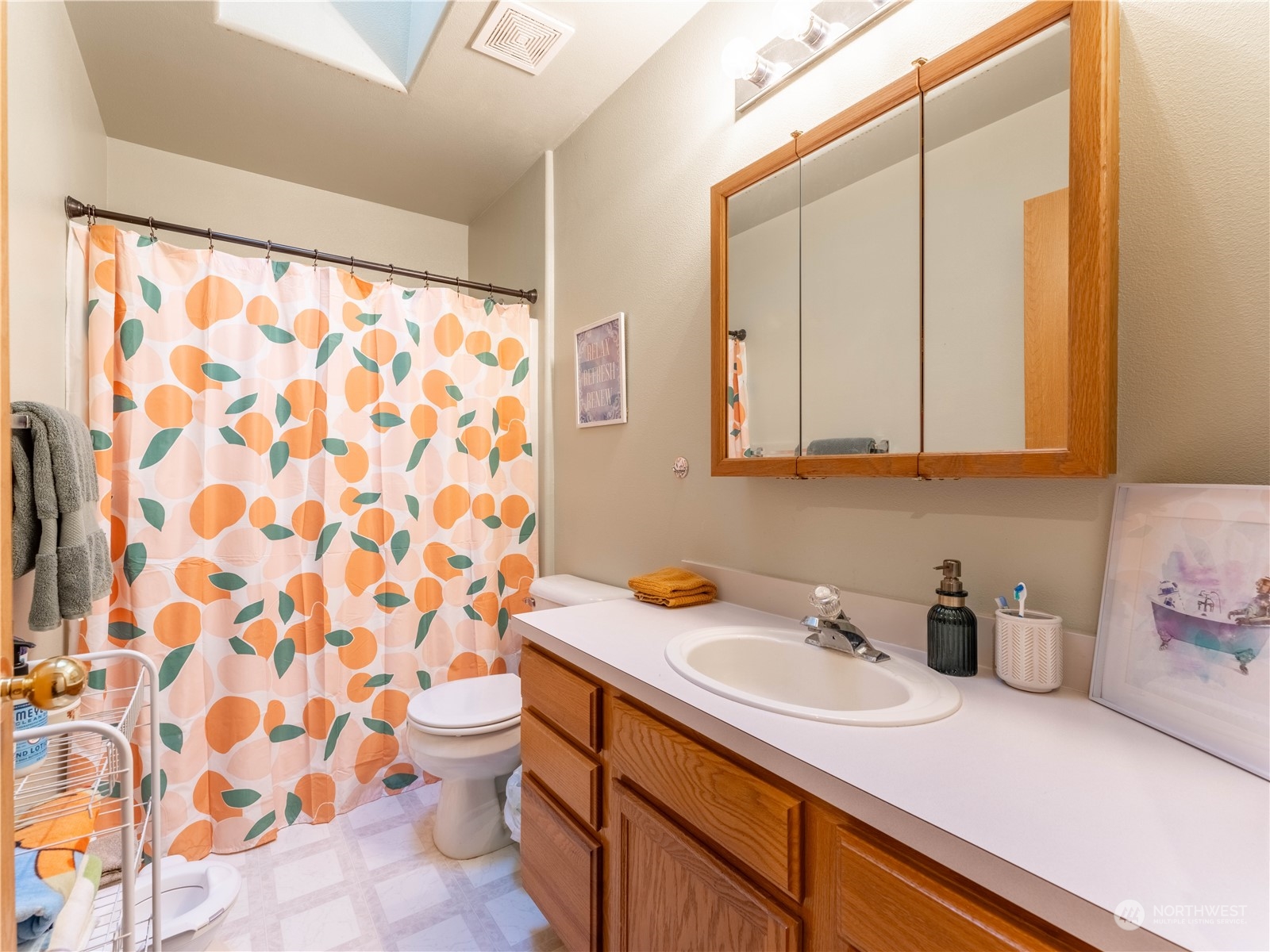 14918 Burkey Street Entiat, WA 98822 - Photo 19 of 39 a bathroom with a sink a toilet and shower curtain