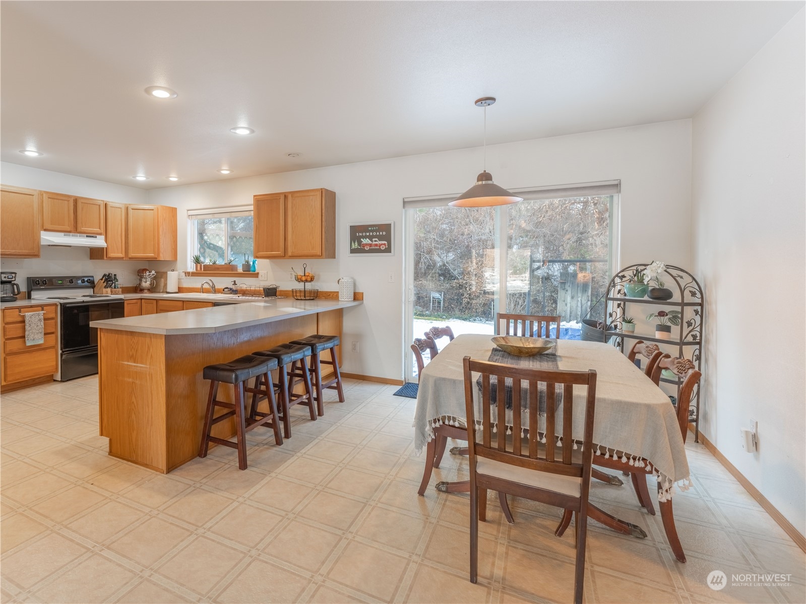 14918 Burkey Street Entiat, WA 98822 - Photo 9 of 39 a dining area with stainless steel appliances a table and chairs