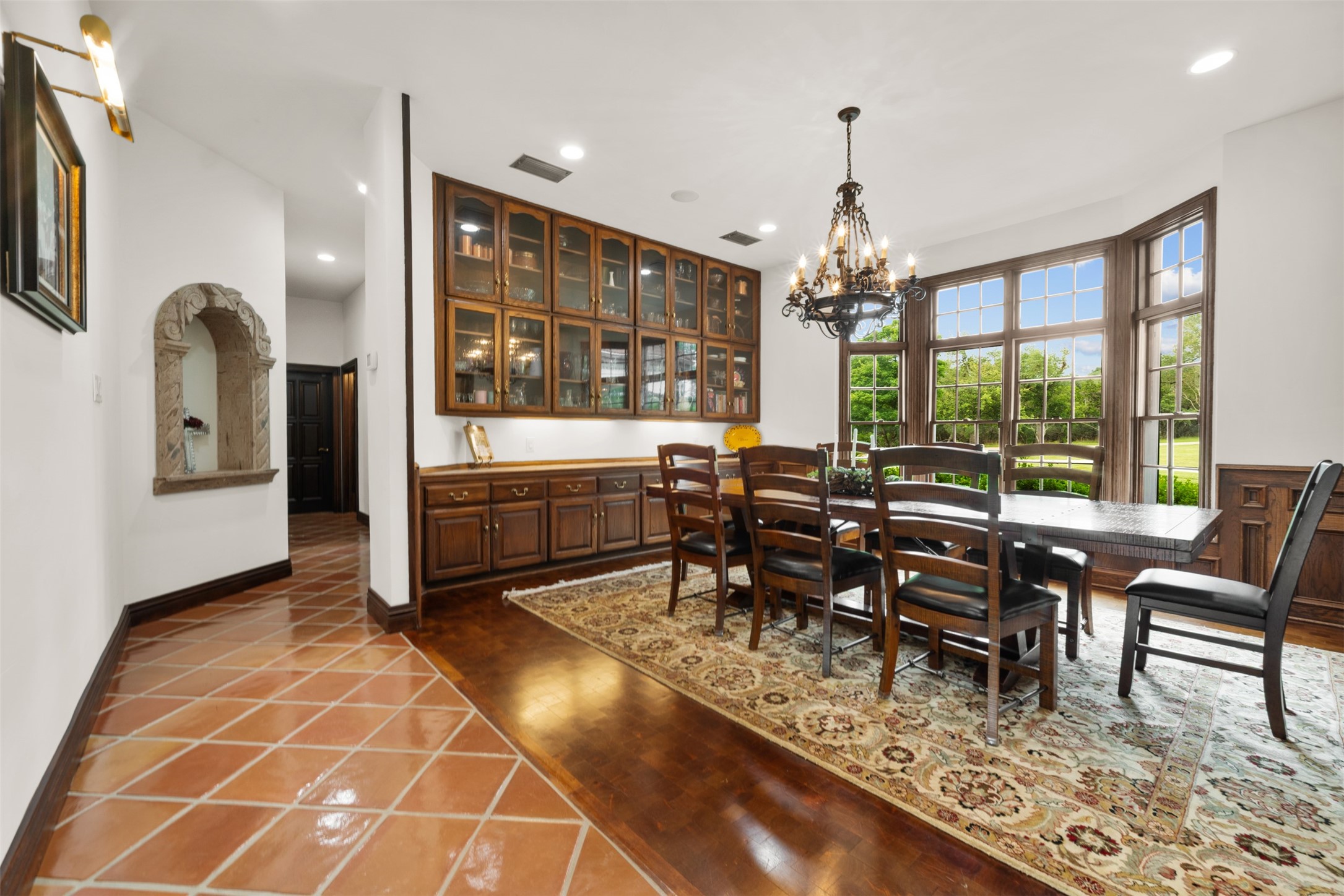 34000 Smithson Valley Road Bulverde, TX 78163 - Photo 5 of 50 Designed for memorable gatherings, the formal dining room features custom built-in cabinetry, hardwood flooring, and picturesque views of the surrounding grounds. Expansive windows fill the space with natural light.